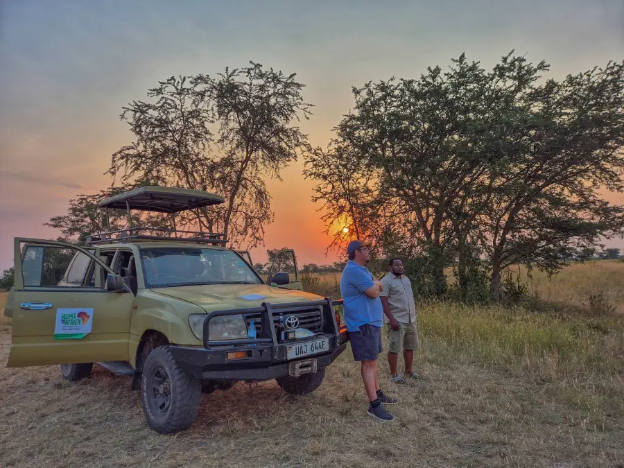Safari vehicle at sunset on the savanna
